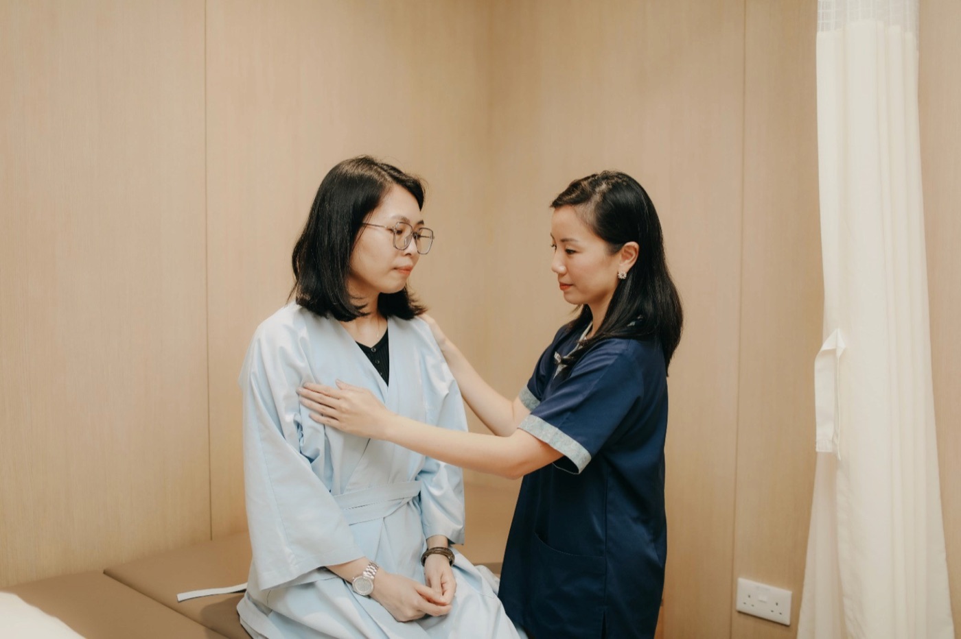 Female oncologist performing a clinical breast examination